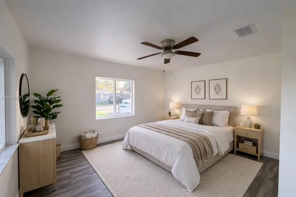 a spacious bedroom with a bed and window