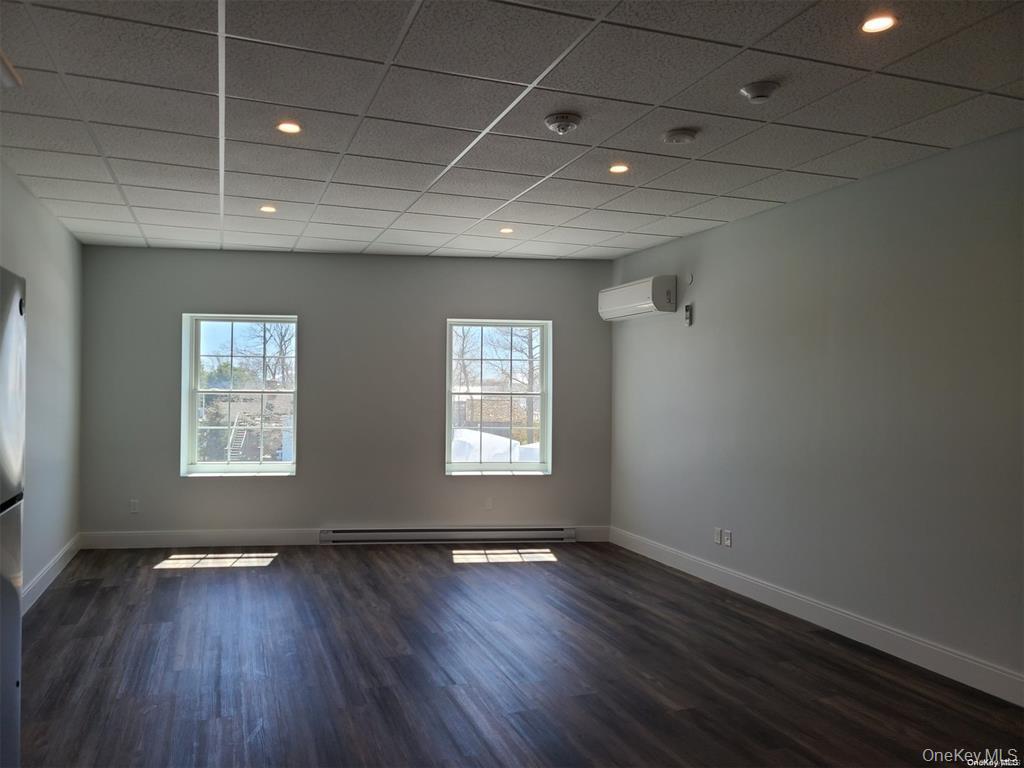 262 East Main Street, Unit D Babylon, NY 11702 - Photo 11 of 17 a view of an empty room with wooden floor and a window