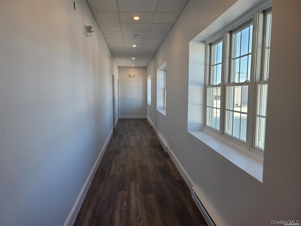 262 East Main Street, Unit D Babylon, NY 11702 - Photo 5 of 17 a view of a hallway with wooden floor