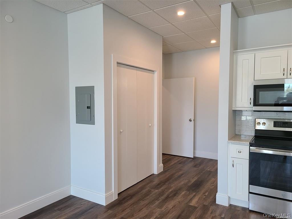 262 East Main Street, Unit D Babylon, NY 11702 - Photo 6 of 17 a view of a kitchen with wooden floor and electronic appliances