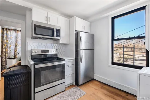 a kitchen with a stove a microwave and a refrigerator