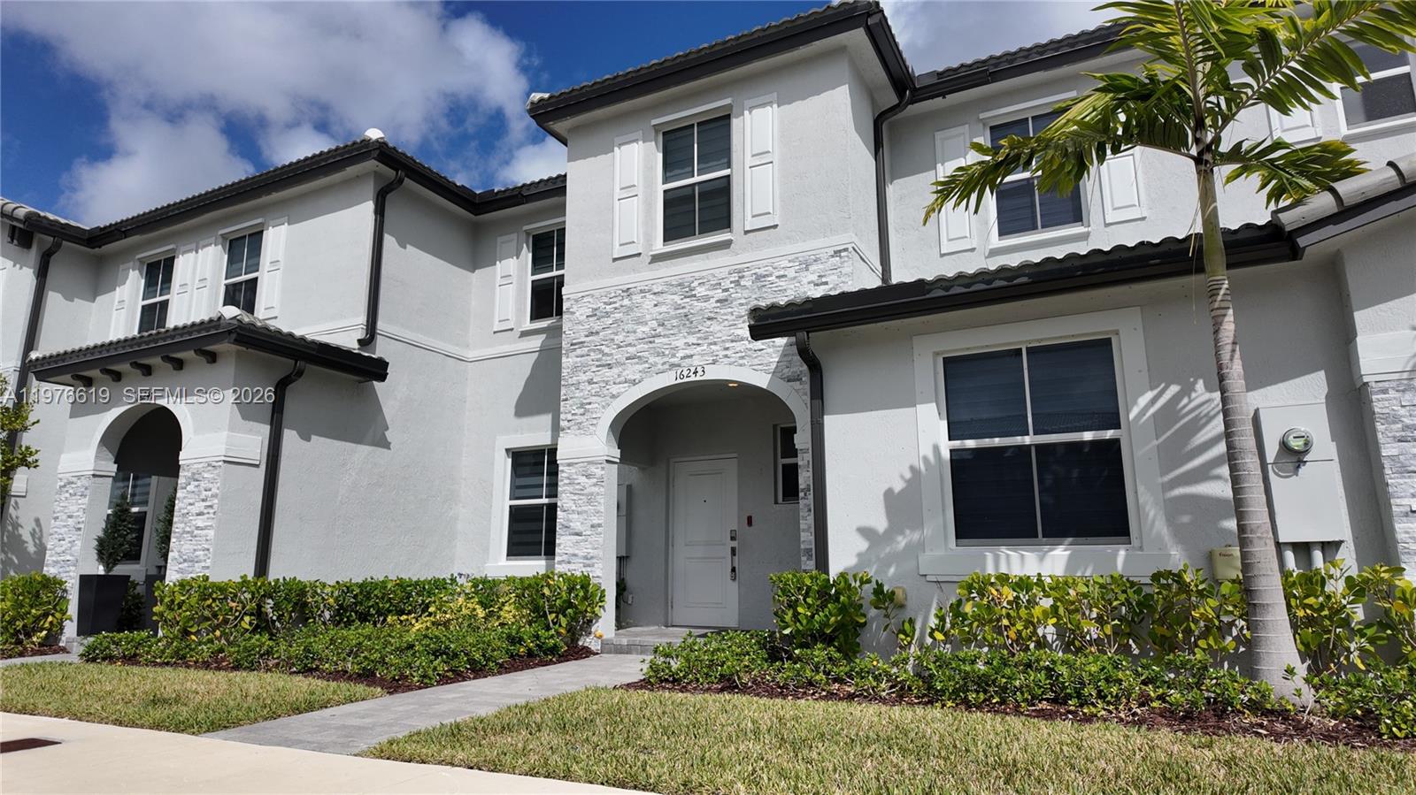 16243 Southwest 292nd Street, Unit 16243 Homestead, FL 33033 - Photo 1 of 30 a front view of a house with windows