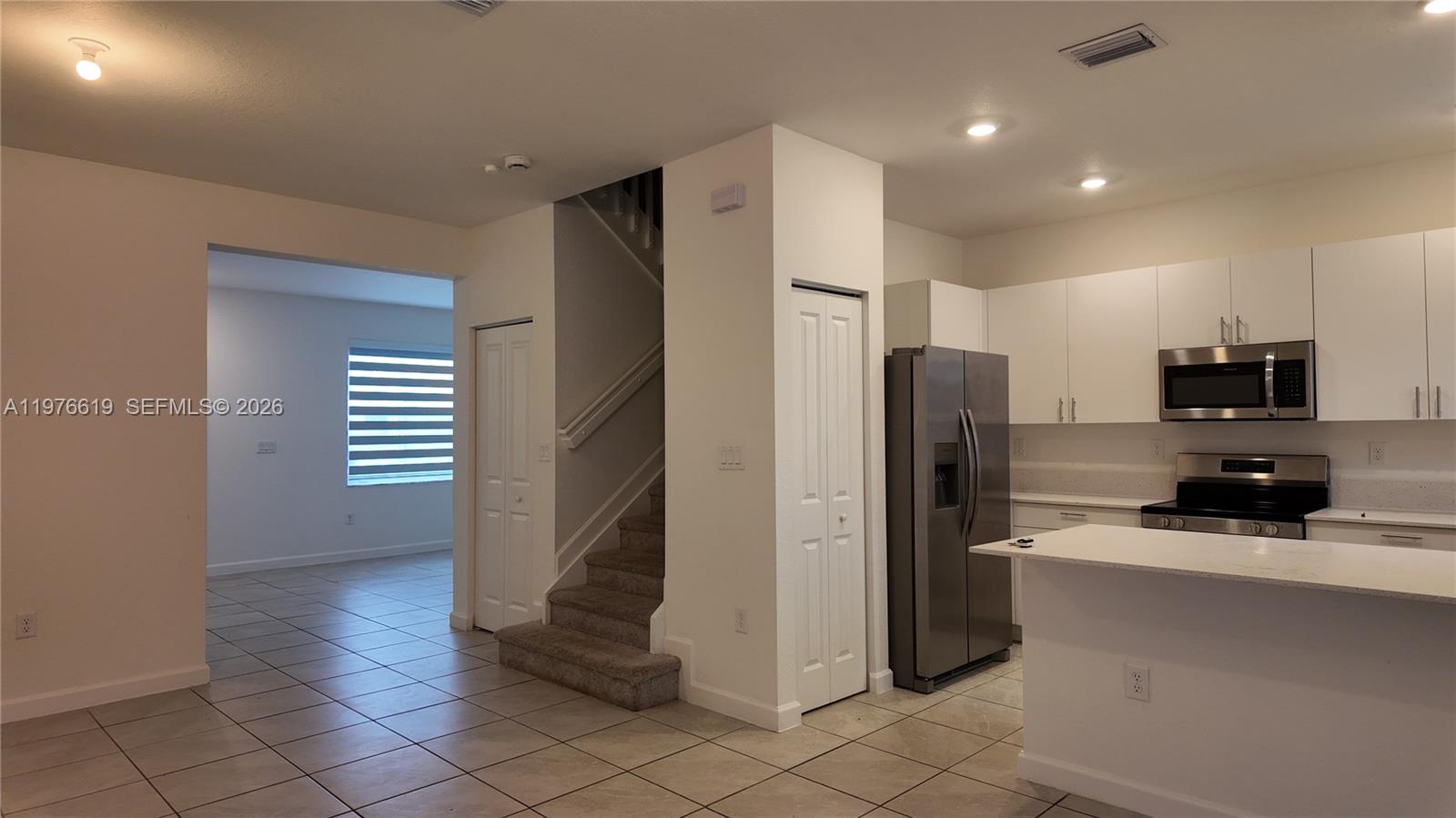 16243 Southwest 292nd Street, Unit 16243 Homestead, FL 33033 - Photo 12 of 30 a kitchen with stainless steel appliances a refrigerator and a stove top oven