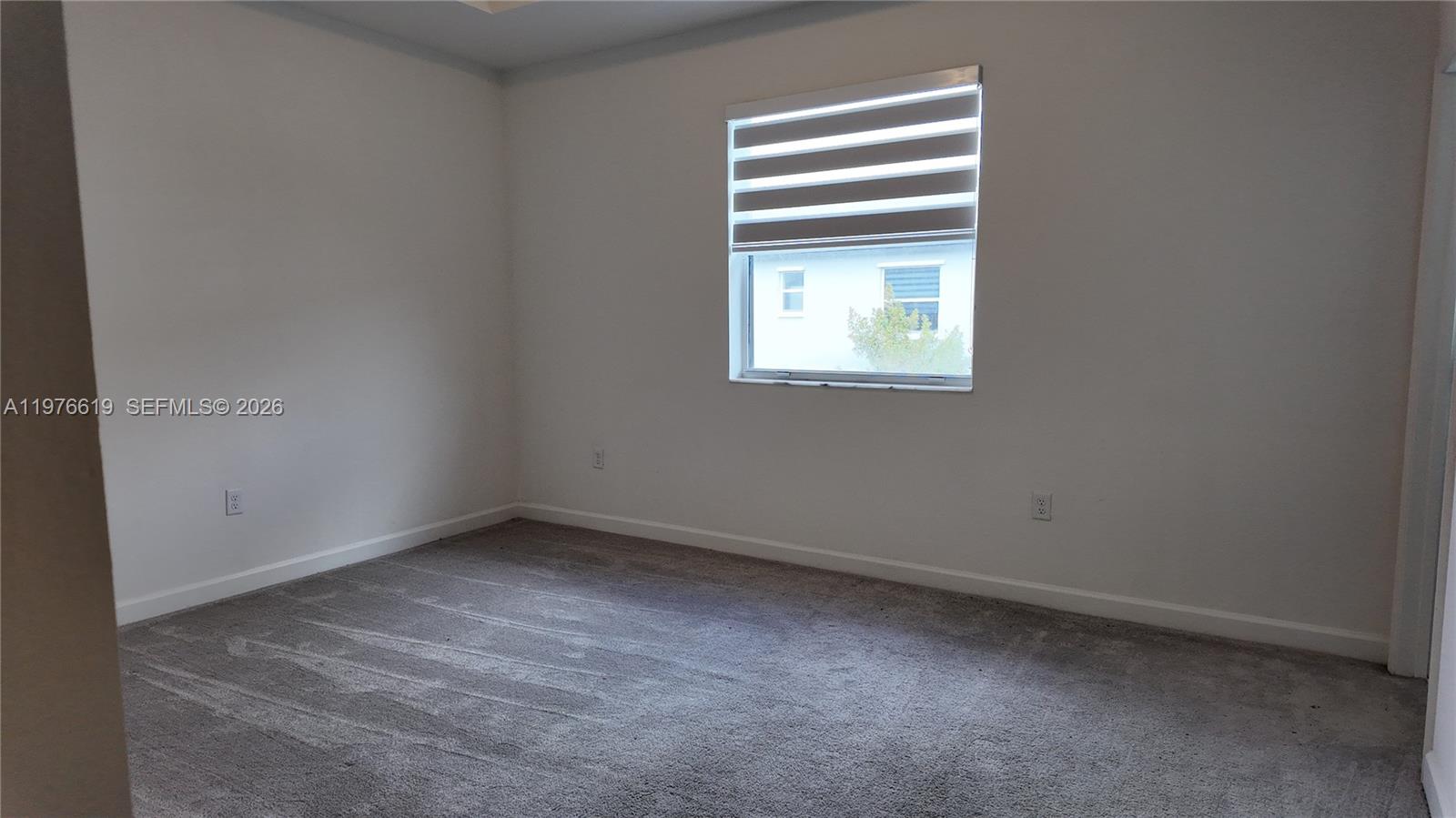 16243 Southwest 292nd Street, Unit 16243 Homestead, FL 33033 - Photo 21 of 30 an empty room with a window