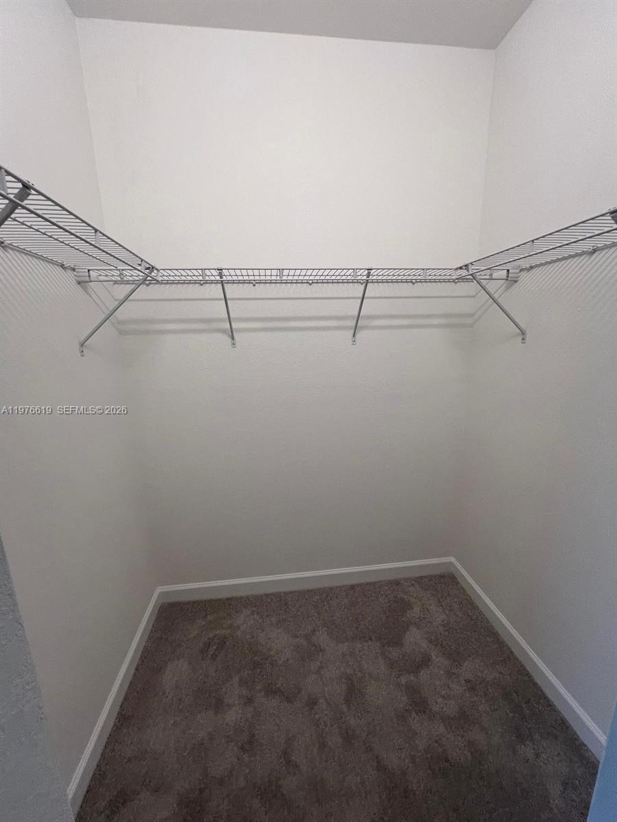 16243 Southwest 292nd Street, Unit 16243 Homestead, FL 33033 - Photo 22 of 30 a view of a room with racks on the wall