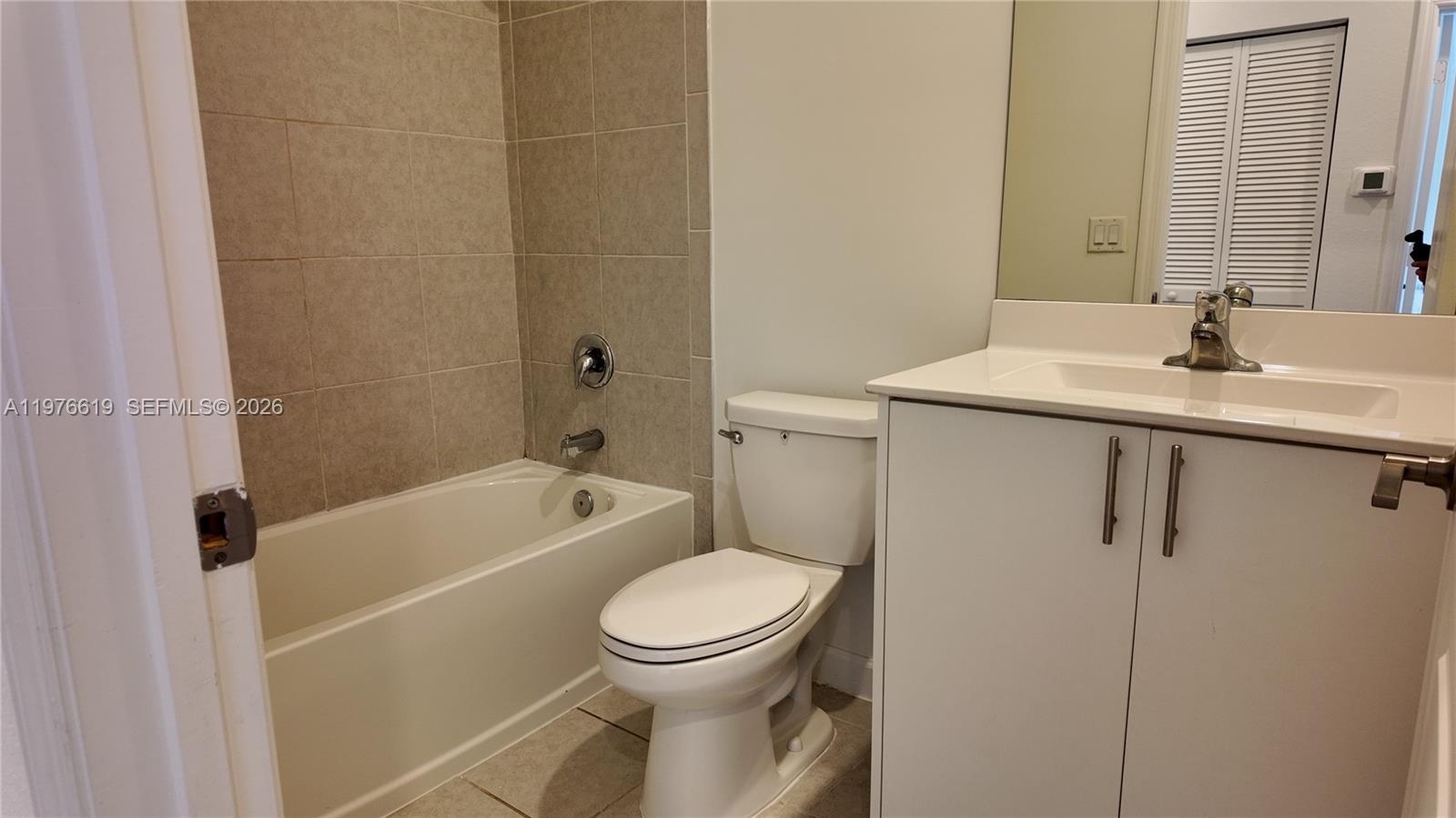 16243 Southwest 292nd Street, Unit 16243 Homestead, FL 33033 - Photo 26 of 30 a bathroom with a toilet a sink and bathtub