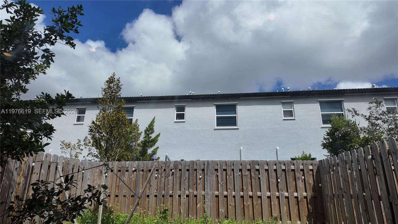 16243 Southwest 292nd Street, Unit 16243 Homestead, FL 33033 - Photo 28 of 30 a front view of a house with a garden