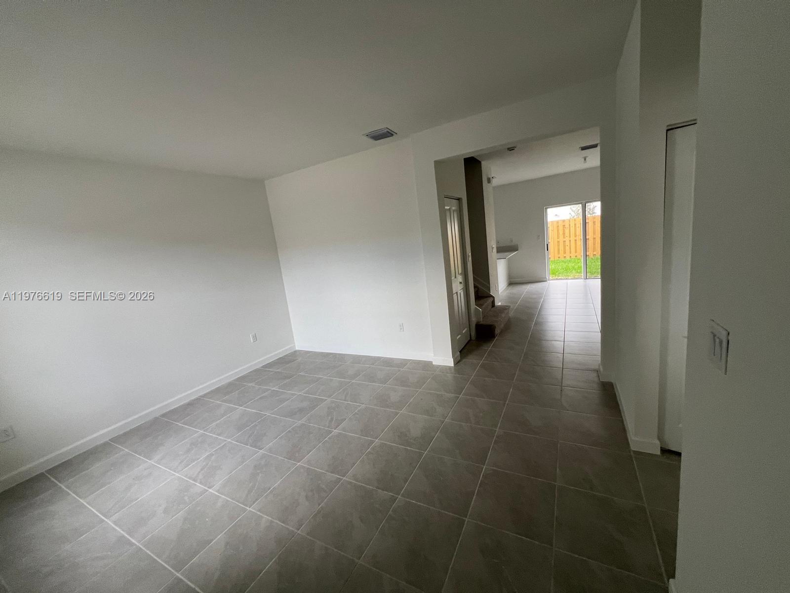 16243 Southwest 292nd Street, Unit 16243 Homestead, FL 33033 - Photo 8 of 30 a view of a hallway with wooden shelves