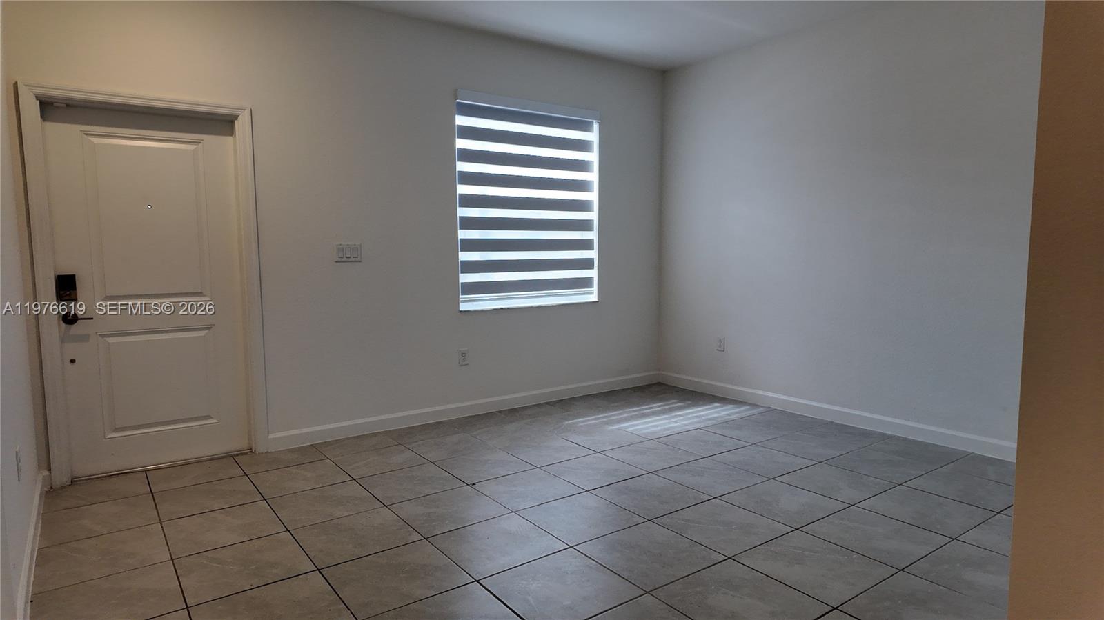 16243 Southwest 292nd Street, Unit 16243 Homestead, FL 33033 - Photo 9 of 30 a view of an empty room and window