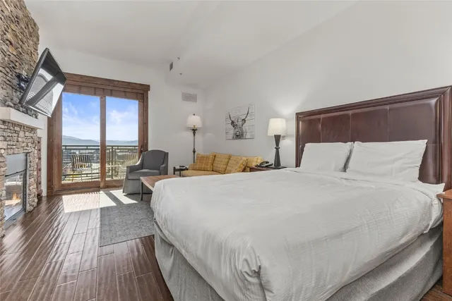 a large bed sitting in a bedroom next to a window