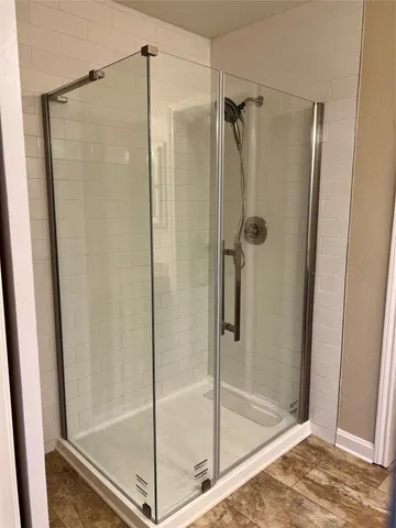 a bathroom with a glass shower door