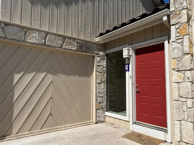 a view of a door and wooden wall