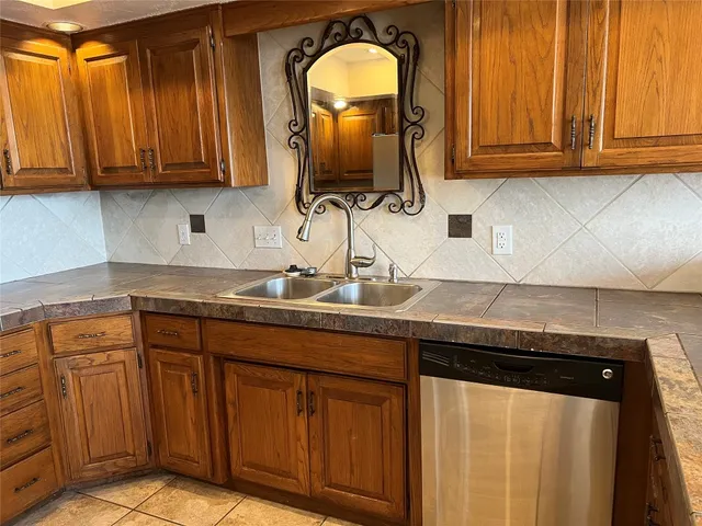 a kitchen with stainless steel appliances granite countertop a sink and cabinets