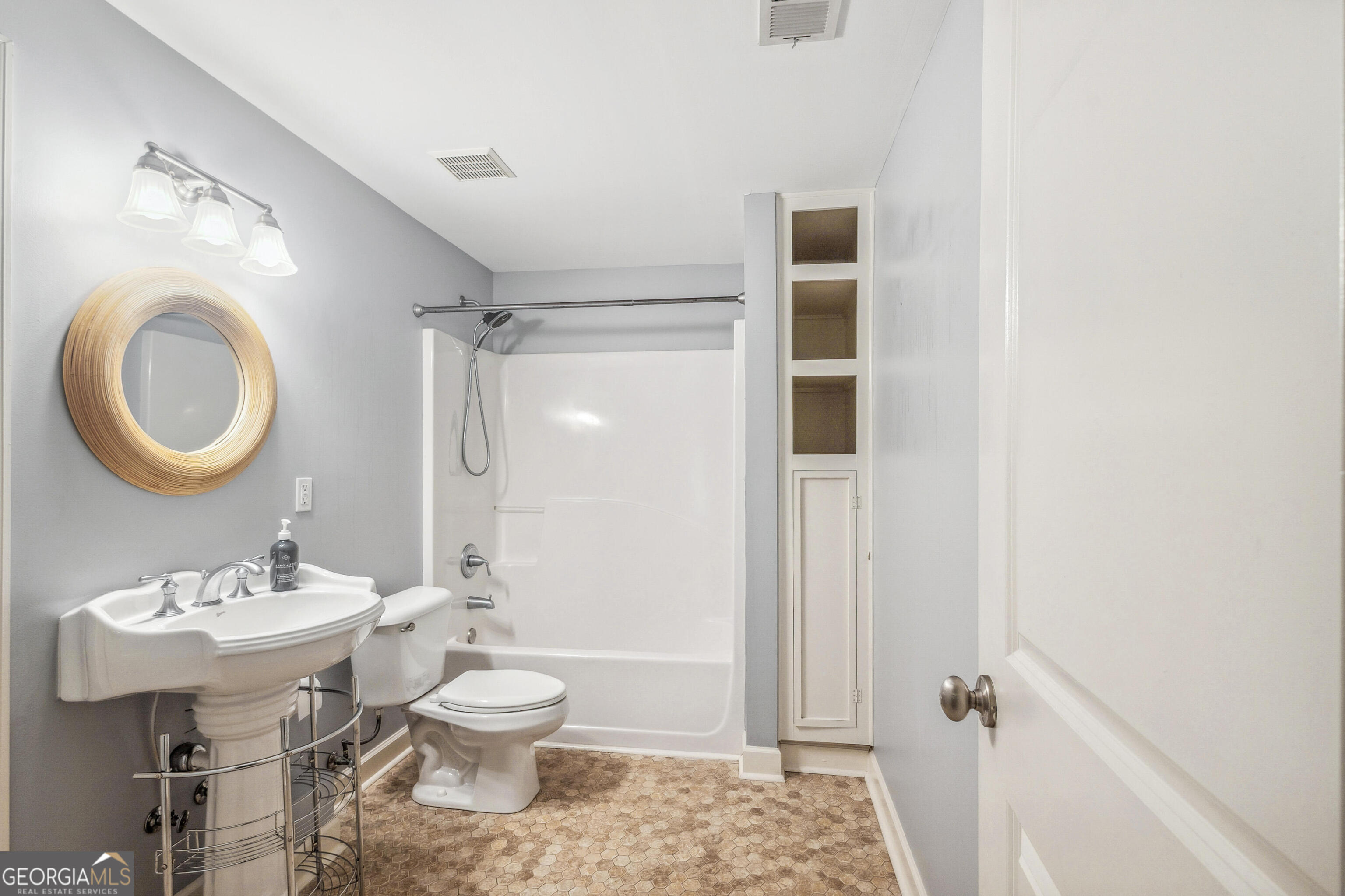 25 The Terrace Newnan, GA 30263 - Photo 27 of 58 a bathroom with a toilet a sink and mirror