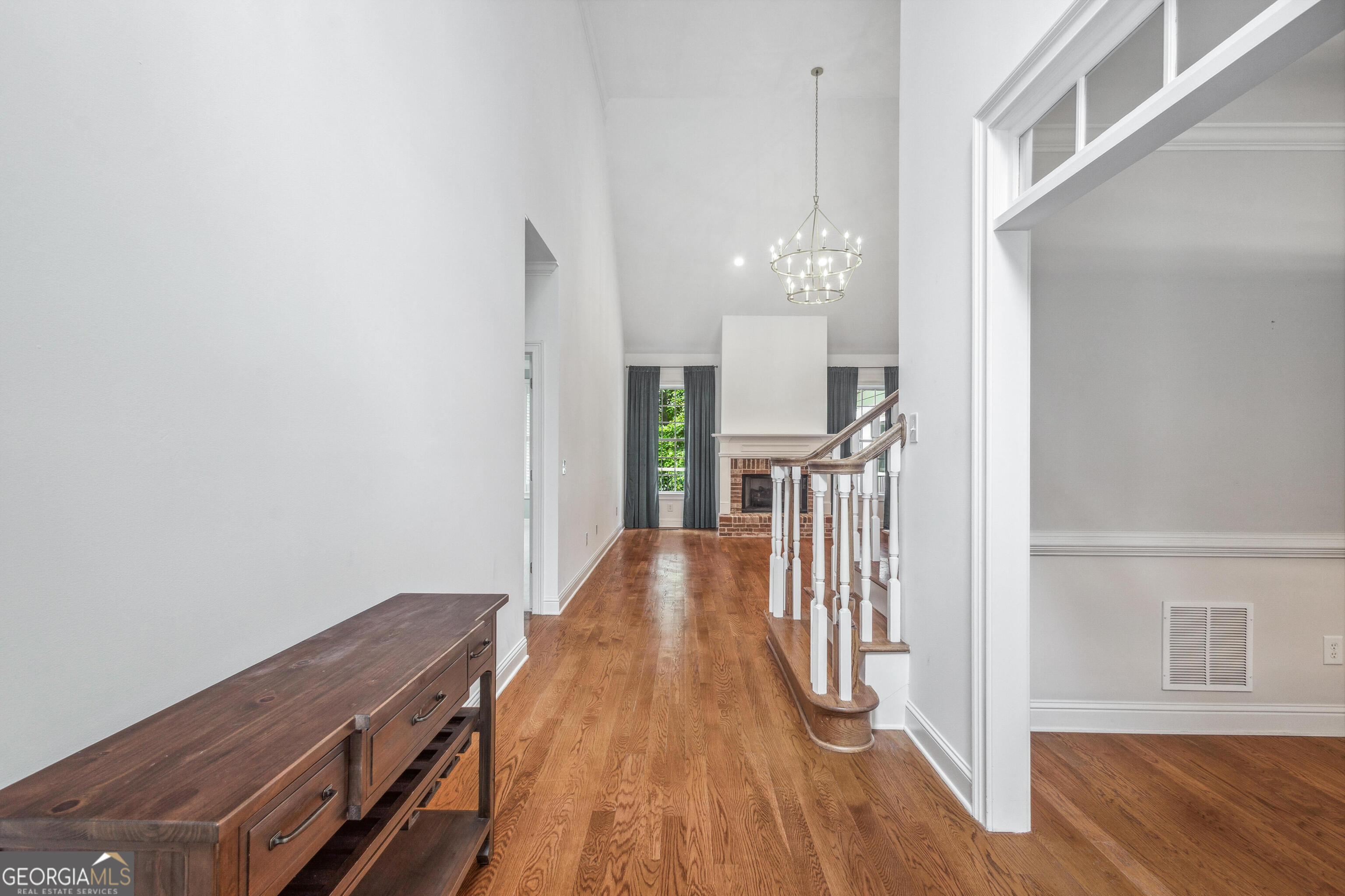 25 The Terrace Newnan, GA 30263 - Photo 3 of 58 a view of a hallway with wooden floor and staircase