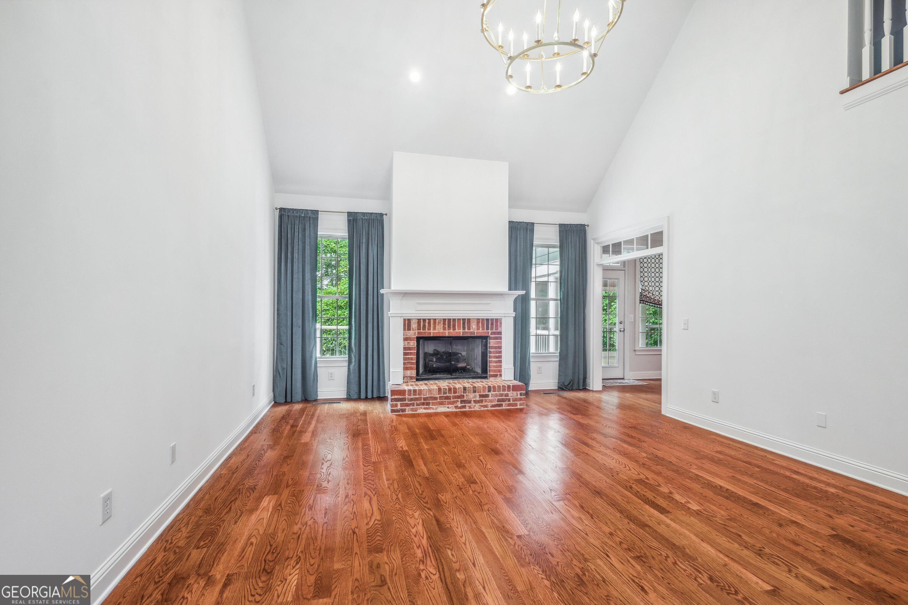 25 The Terrace Newnan, GA 30263 - Photo 6 of 58 a view of an empty room with wooden floor fireplace and a window
