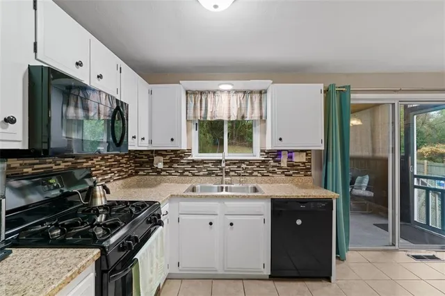 a kitchen with a stove a sink and a refrigerator