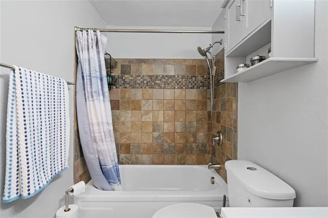 a bathroom with a bathtub and shower