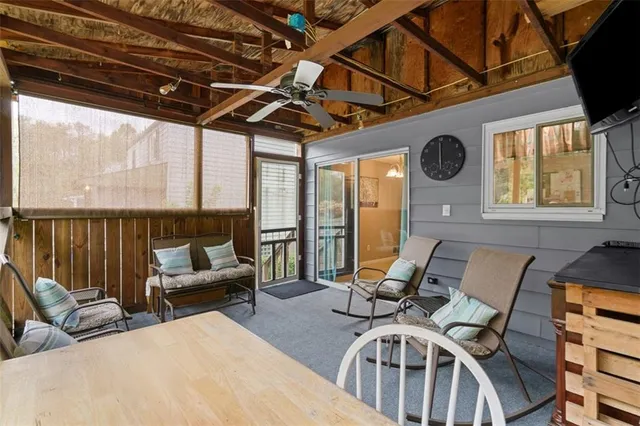 a view of a patio with couches chairs and a wooden floor