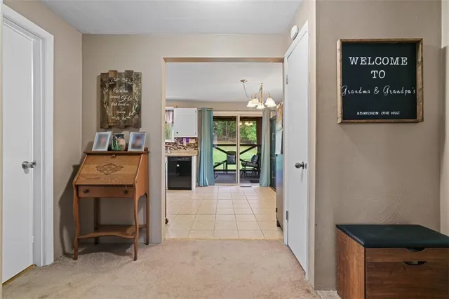 a view of a hallway to rooms and livingroom with furniture