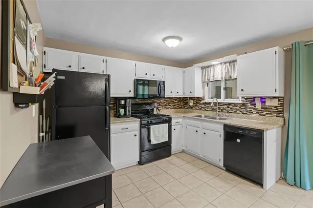 a kitchen with a refrigerator stove and sink