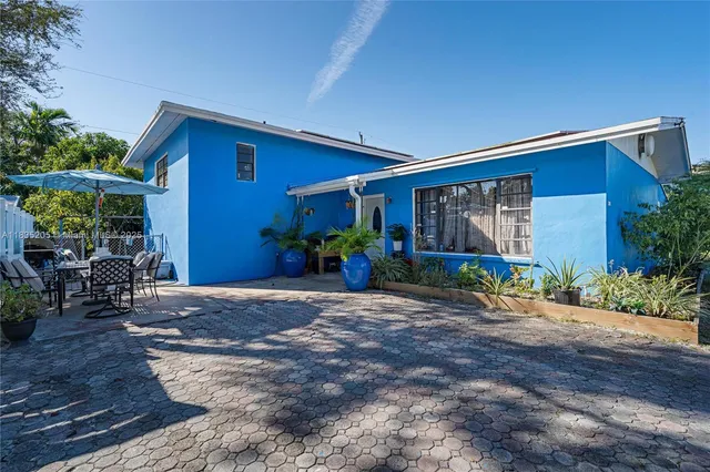 a front view of a house with garden and patio