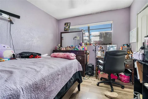 a bedroom with bed and a window