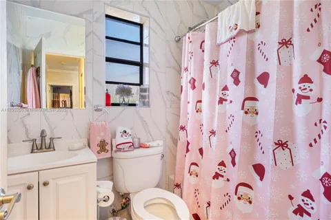 a white toilet sitting next to a bathroom sink