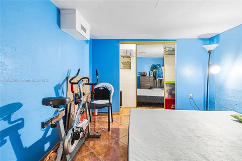 a bedroom with furniture and a mirror