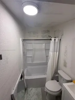 a bathroom with a toilet and a bathtub