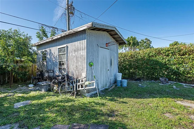 a yellow house with trees in front of it