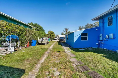 a view of a backyard with table and chairs with wooden fence
