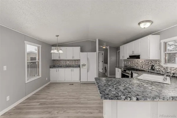 a large kitchen with kitchen island a sink stainless steel appliances and cabinets