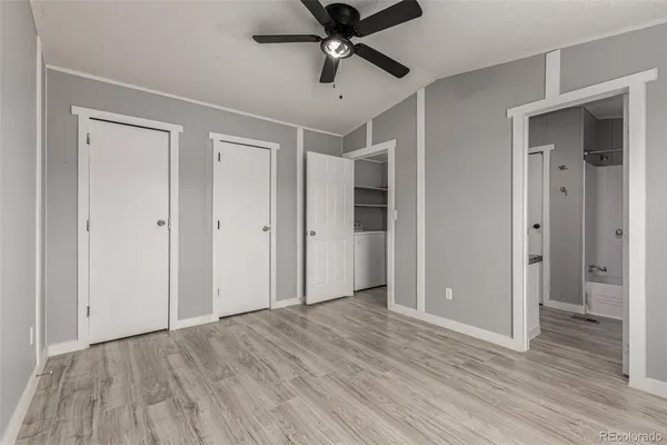 a view of empty room with wooden floor