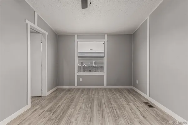 a view of room with closet and wooden floor