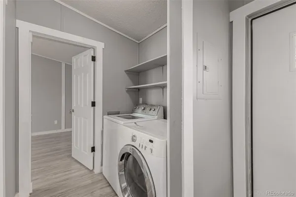 a view of walk in closet with washer and dryer