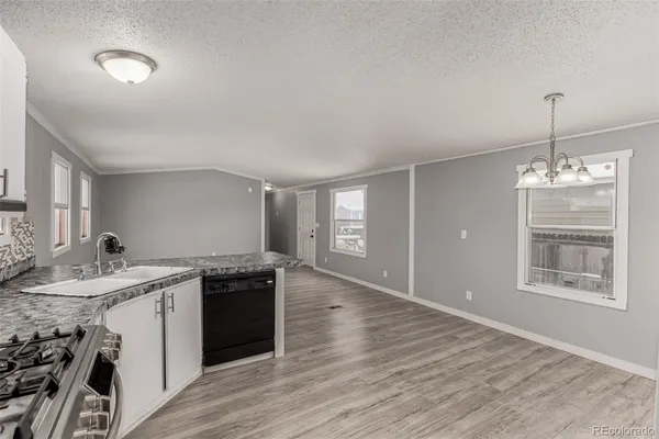a kitchen with a sink stove and cabinets