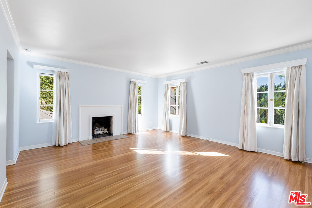 2120 Outpost Drive Los Angeles, CA 90068 - Photo 12 of 37 a view of empty room with wooden floor and fireplace