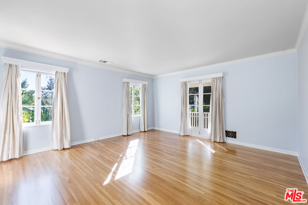 2120 Outpost Drive Los Angeles, CA 90068 - Photo 13 of 37 a view of an empty room with wooden floor and a window
