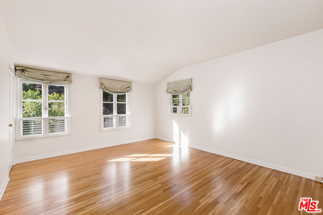 2120 Outpost Drive Los Angeles, CA 90068 - Photo 17 of 37 a view of an empty room with wooden floor and a window