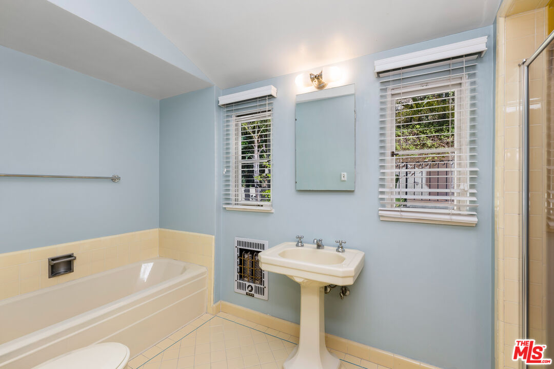 2120 Outpost Drive Los Angeles, CA 90068 - Photo 18 of 37 a bathroom with a sink a bathtub and a window
