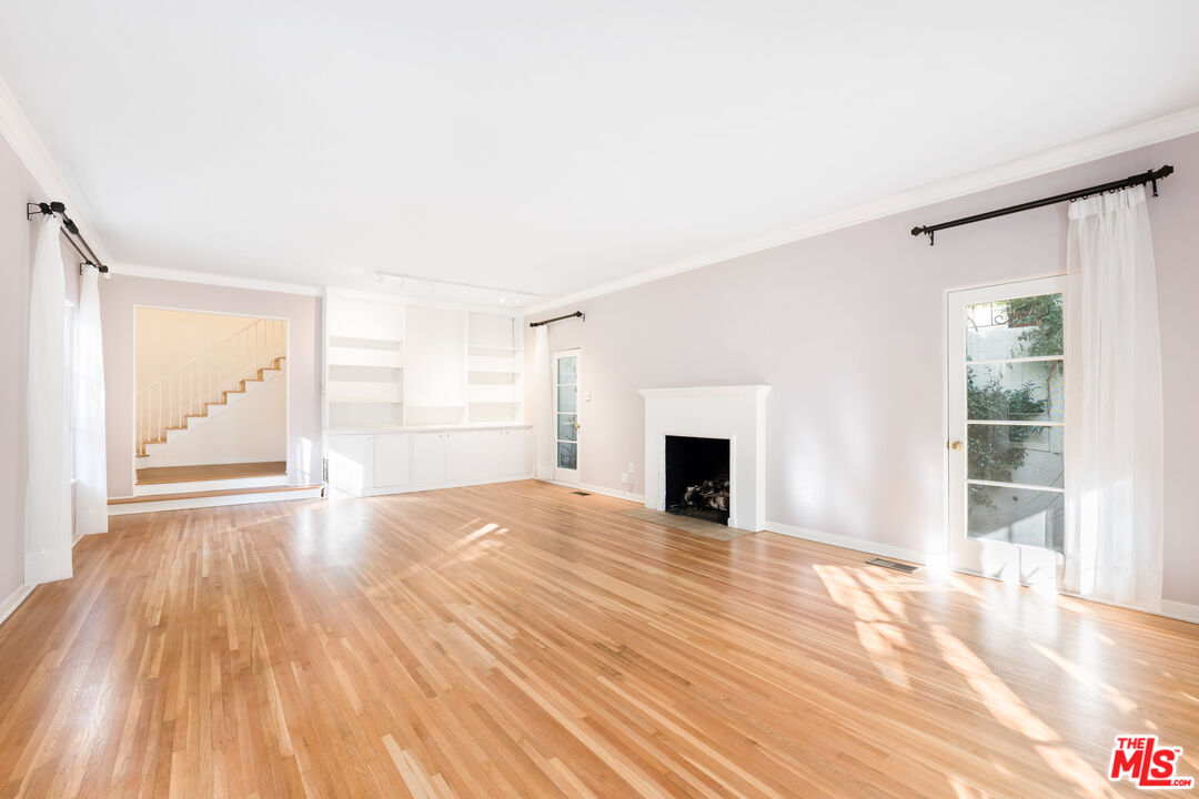 2120 Outpost Drive Los Angeles, CA 90068 - Photo 2 of 37 a view of empty room with wooden floor and fireplace