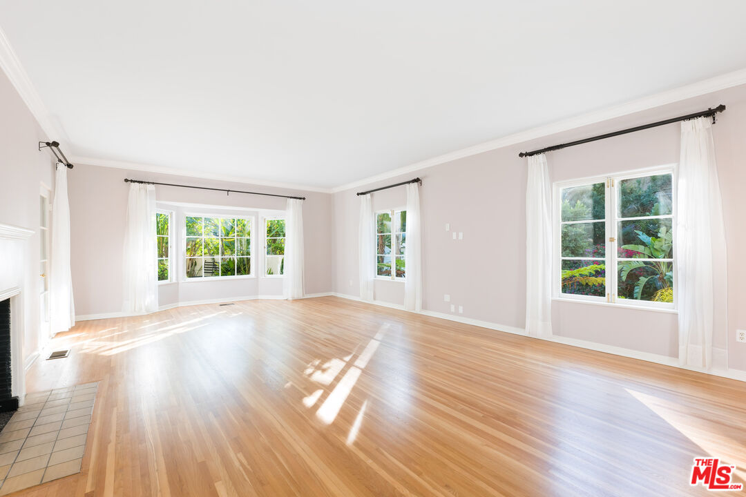 2120 Outpost Drive Los Angeles, CA 90068 - Photo 3 of 37 an empty room with wooden floor and windows