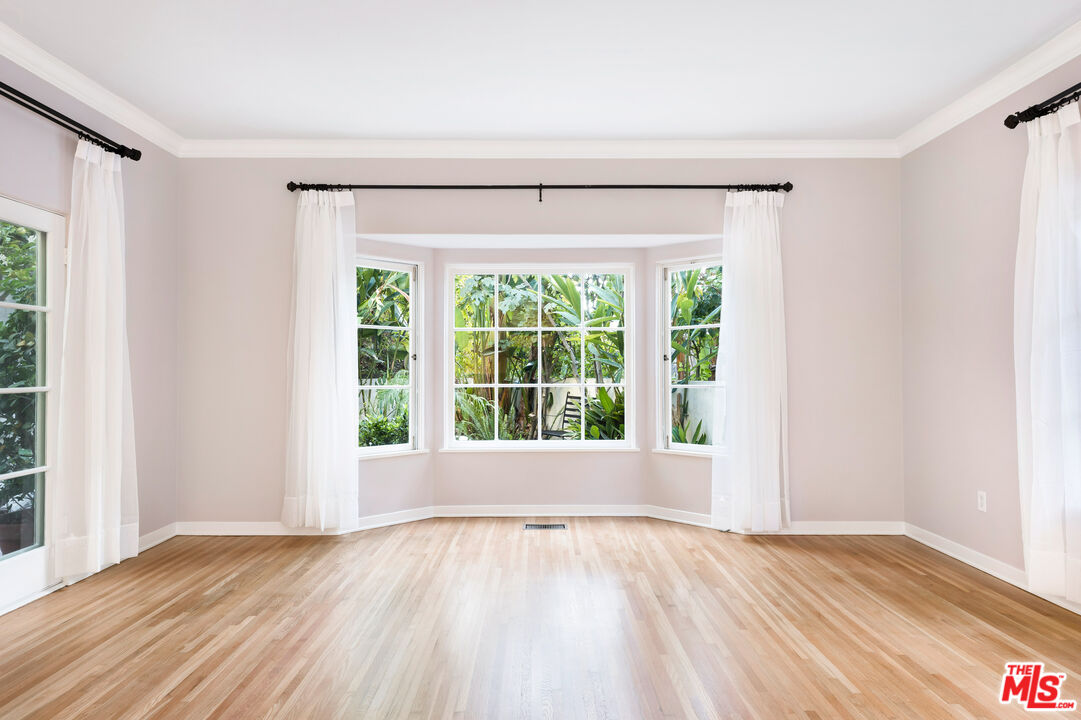 2120 Outpost Drive Los Angeles, CA 90068 - Photo 4 of 37 a view of an empty room with wooden floor and a window