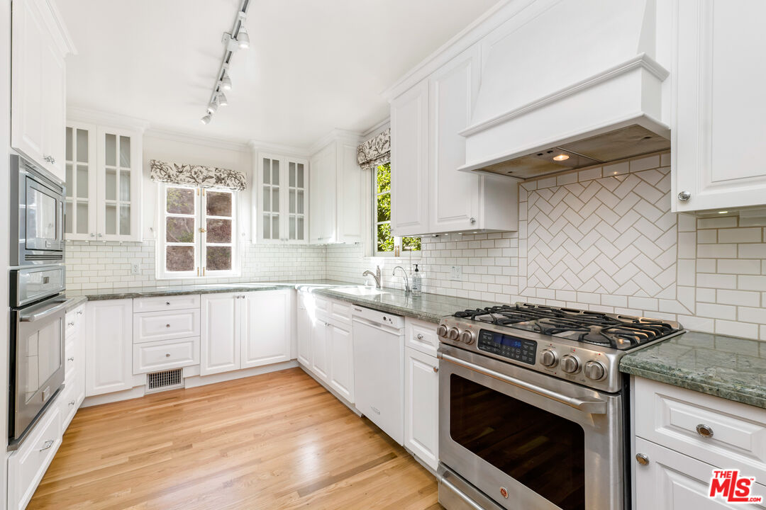 2120 Outpost Drive Los Angeles, CA 90068 - Photo 7 of 37 a kitchen with stainless steel appliances granite countertop a stove and a sink