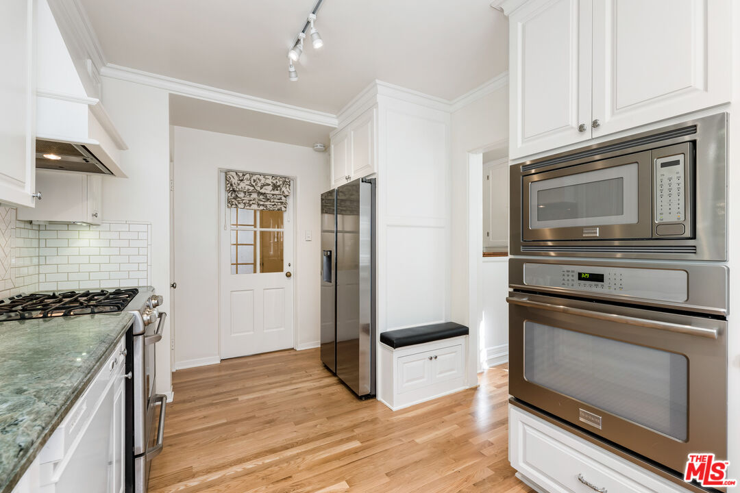 2120 Outpost Drive Los Angeles, CA 90068 - Photo 8 of 37 a kitchen with granite countertop cabinets stainless steel appliances and wooden floor