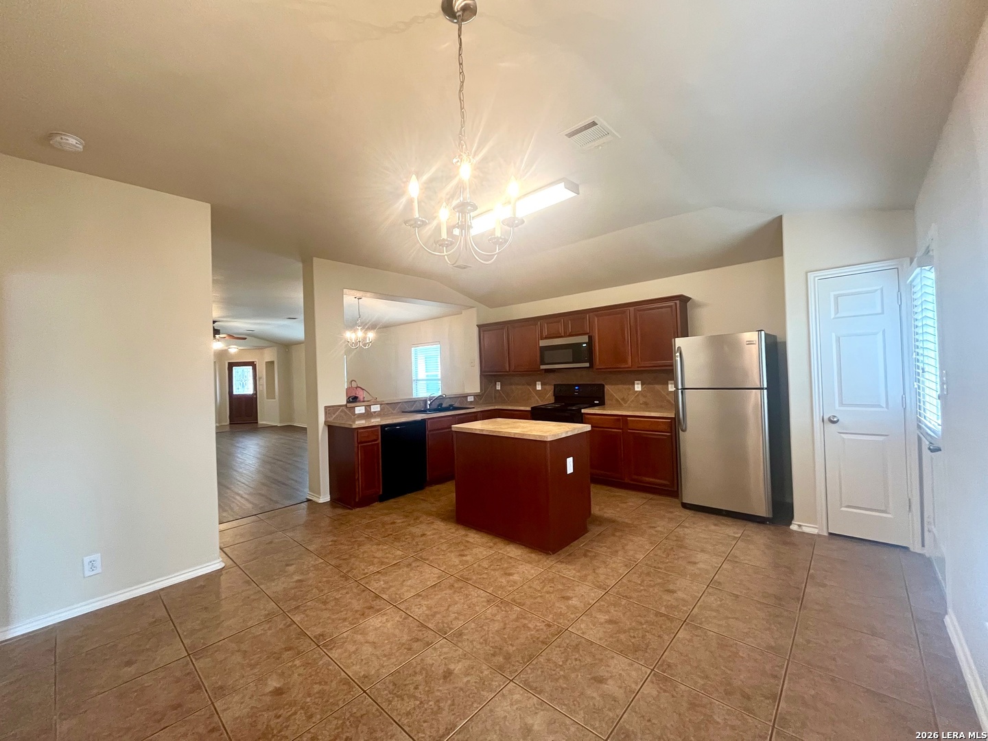 225 Brahma Way Cibolo, TX 78108 - Photo 11 of 24 a kitchen with stainless steel appliances kitchen island granite countertop a refrigerator and a view of living room