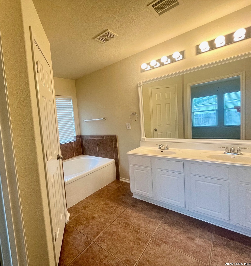225 Brahma Way Cibolo, TX 78108 - Photo 14 of 24 a bathroom with a tub sink and mirror