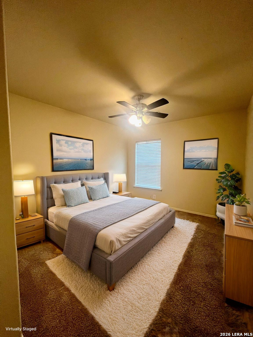 225 Brahma Way Cibolo, TX 78108 - Photo 19 of 24 a bedroom with a bed and a chandelier