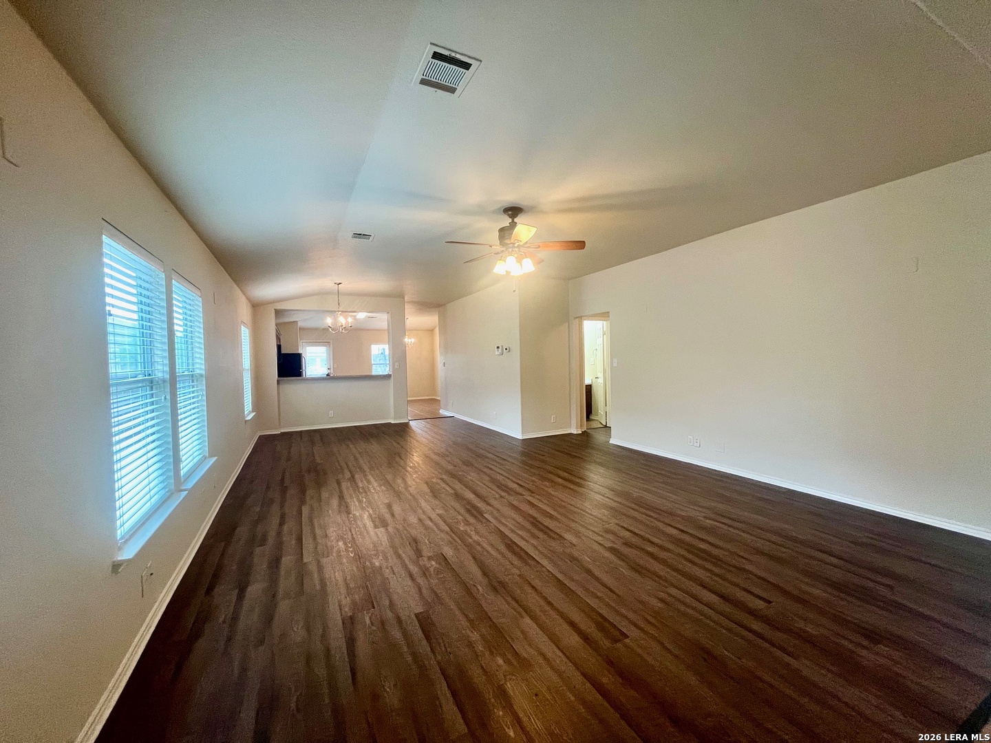 225 Brahma Way Cibolo, TX 78108 - Photo 8 of 24 a view of an empty room with wooden floor and a window